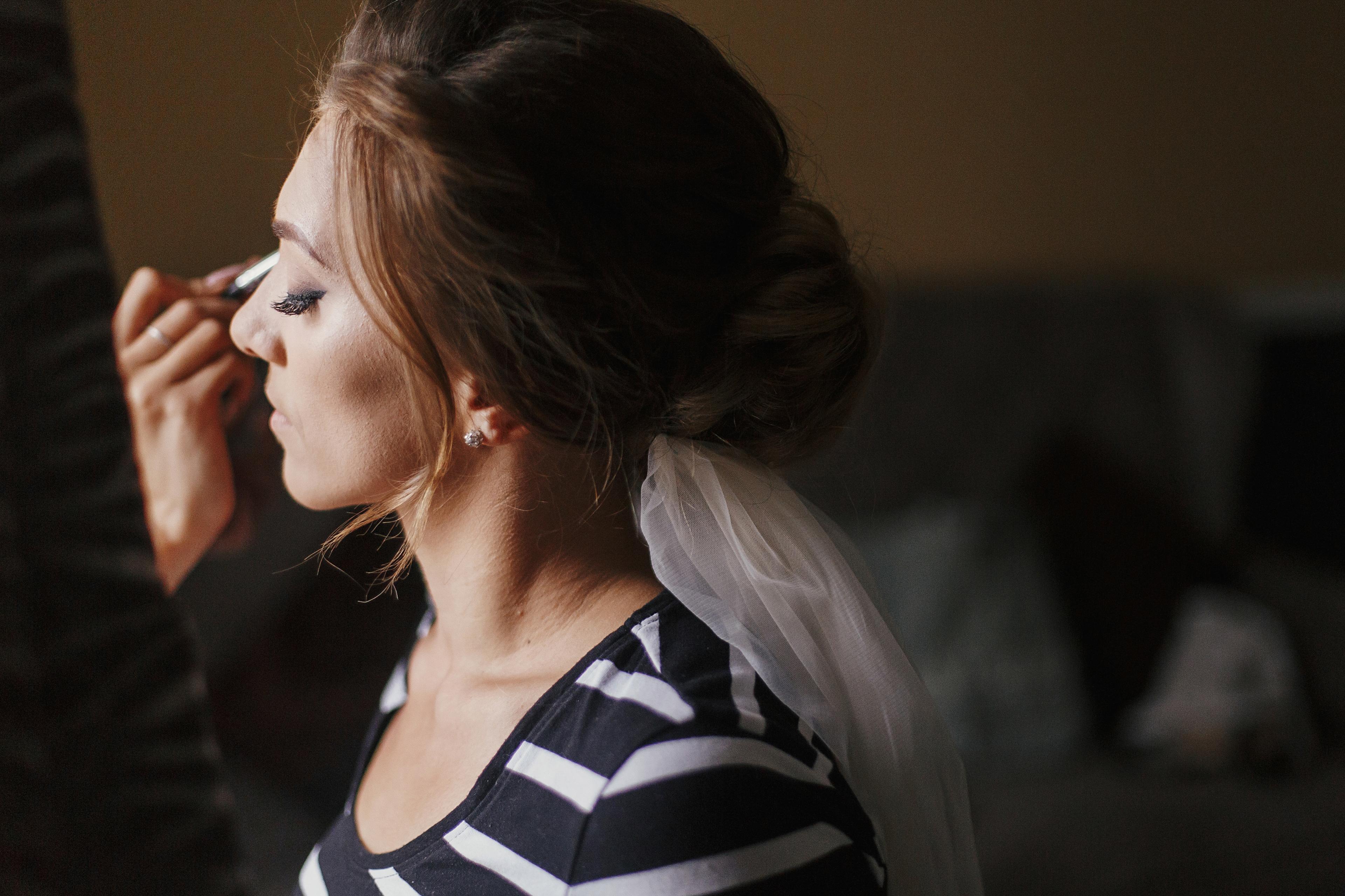 Wedding makeup artist applying eyeshadow and brows at Lumora Belle Beauty, Loughborough